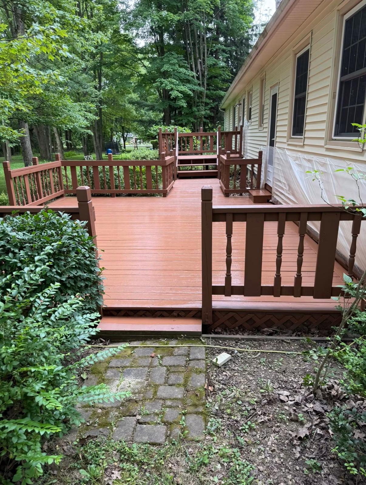 Deck and railings finished in a rich reddish-brown stain